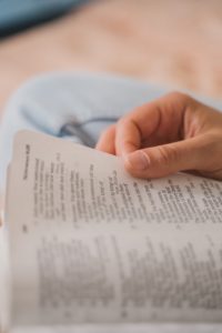 closeup hand reading bible