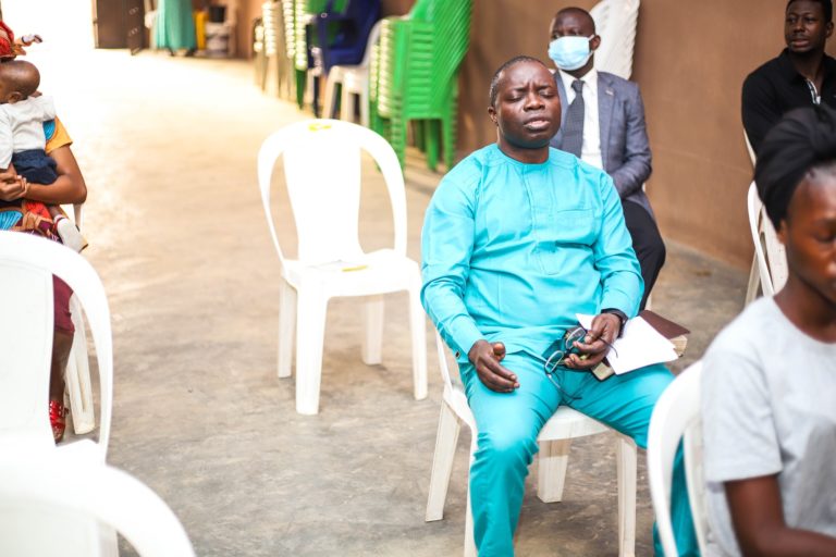 african man praying in church