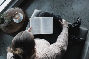 woman reading bible with coffee