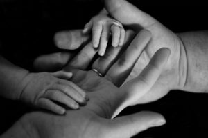 mother father and child hands black and white