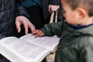 boy and father reading bible