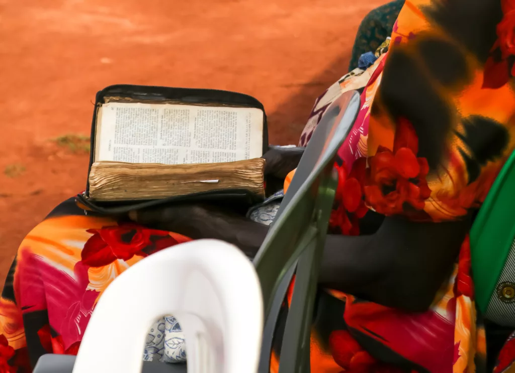 ugandan woman holding an open bible